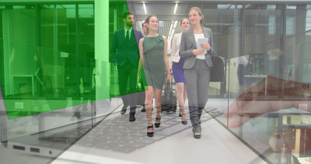 Image of hands using laptop with green screen over colleagues walking in corridor with suitcases. business and communication technology concept digitally generated image.の写真素材