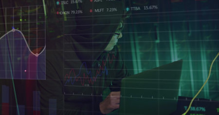Image of data over asian male hacker in hoodie using laptop by computer server. online security, data processing, cloud computing concept and technology concept digitally generated image.の写真素材