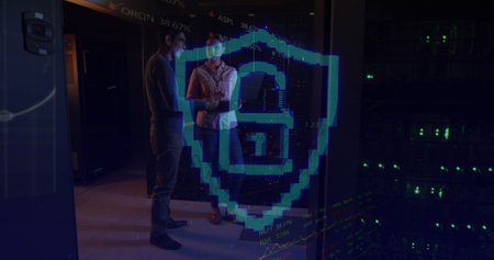 Image of padlock over diverse female and male it engineers by computer servers. data processing, cloud computing concept and technology concept digitally generated image.の写真素材