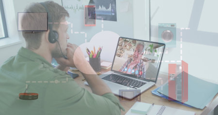 Caucasian man in a headset is on a video call with a senior man. They are discussing work or family...