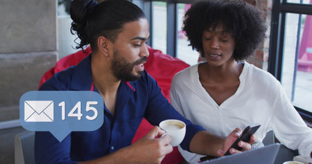 Image of social media icons of over diverse man and woman in restaurant. global networks, business...