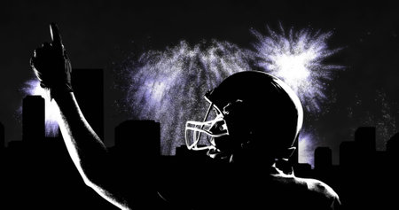 Image of cityscape and fireworks over male american football player pointing finger. sport and...