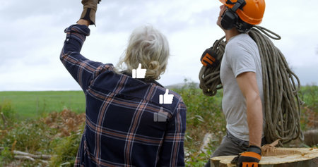 Image of falling icons over two lumberjacks. Global connections, data processing and digital interface concept digitally generated image.の写真素材