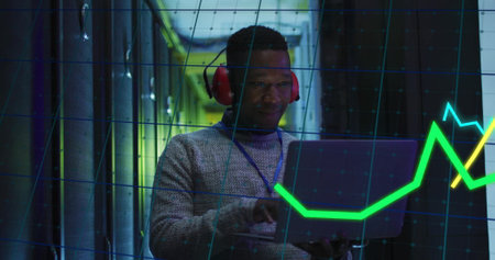 Image of financial data processing over african american businessman in server room. Global business, communication and digital interface concept digitally generated image.の写真素材
