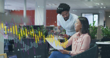 Image of graphs processing data over diverse male and female colleague talking at casual office....