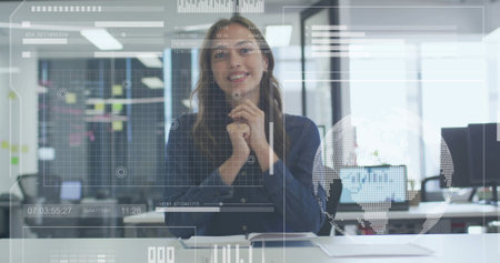 Image of data processing over happy caucasian businesswoman having image call at casual office. Network, data, digital interface, business and communication, digitally generated image.の写真素材