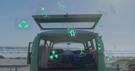 Image of energy and ecology icons over camper van at beach. Vacations, travel, lifestyle, digital interface, energy, connection and communication, digitally generated image.の写真素材