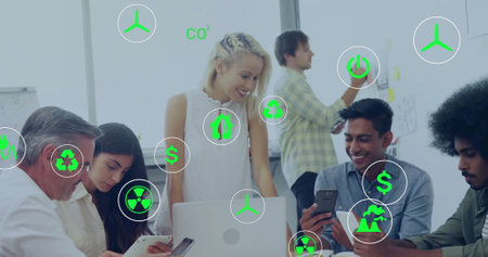 Image of eco icons and data processing over diverse business people in office. Global finance, business, connections, computing and data processing concept digitally generated image.の写真素材