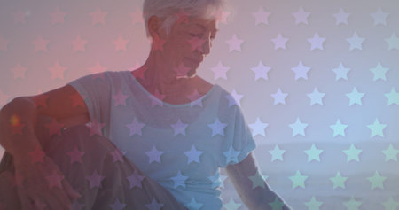 Senior Caucasian woman with grey hair looks contemplative. She is surrounded by a dreamy backdrop...