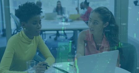 Image of financial data processing over diverse business people using laptop. Global finance, business, connections, computing and data processing concept digitally generated image.の写真素材