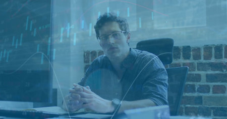 Image of financial data processing over caucasian businessman in office. Global finance, business, connections, computing and data processing concept digitally generated image.の写真素材