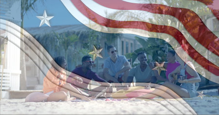 Image of american flag elements over happy diverse friends hanging out on sunny beach. Celebration, america, summer, friendship, togetherness, fun and vacations, digitally generated image.の写真素材