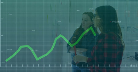 Financial graph image over two women discussing in office. Business, finance, meeting, discussion,...
