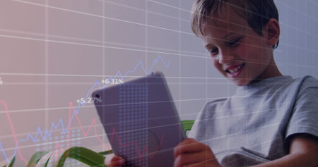 Image of data processing over caucasian boy using tablet. Global technology, computing and digital interface concept digitally generated image.の写真素材