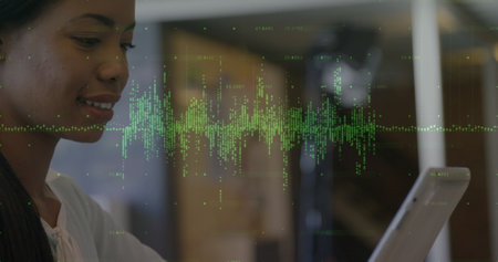 Image of data processing over biracial woman using tablet. Global business, computing and digital interface concept digitally generated image.の写真素材