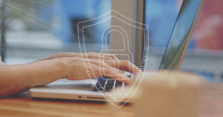 Image of padlock icon and light trails over hands using laptop. Global technology, online security...