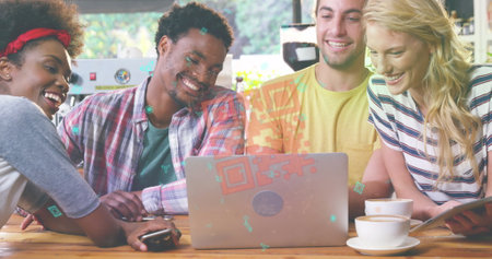A group of friends are using a laptop in a cafe while enjoying cup of coffee. A qr code flashes in...