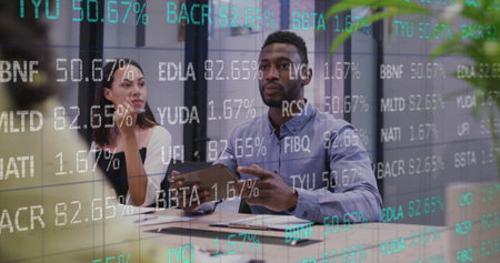 Image of stock market over diverse colleagues having meeting in office. Business, finances and communication concept digitally generated image.の写真素材