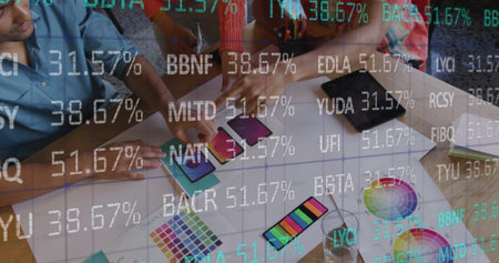 Image of stock market over diverse designers having meeting in office. Business, finances and...