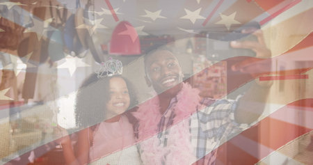 Image of flag of united states of america over african american father and daughter having fun....