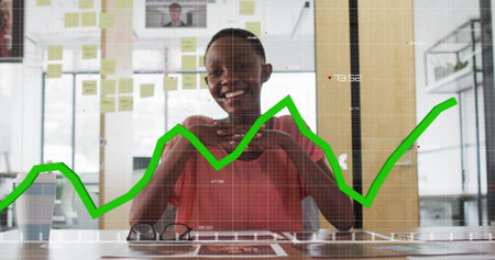 Financial data graph image over smiling businessperson in office with sticky notes. finance,...