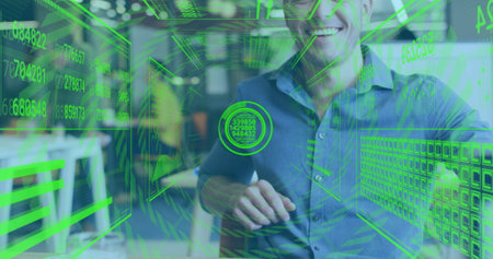 Smiling man in office with green holographic data processing image over him. Technology, business, innovation, analytics, futuristic, digitalの写真素材