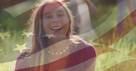 Composite image of american flag over portrait of caucasian female volunteer smiling in the forest....