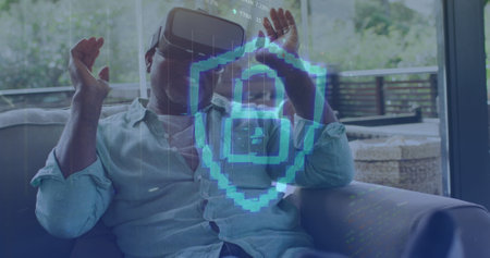 Image of padlock icon and data processing over african american man using vr headset. global technology, connections and digital interface concept digitally generated image.の写真素材