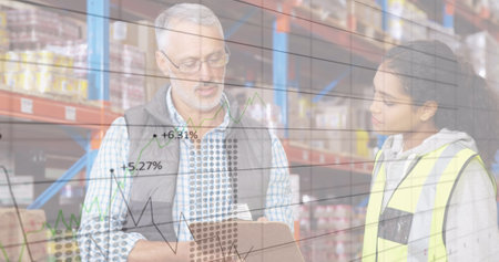 Image of financial graphs over diverse female and male warehouse workers making notes. business, finance and delivery services concept digitally generated image.の写真素材