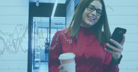Image of financial data over caucasian businesswoman with coffee and smartphone in office. business,...
