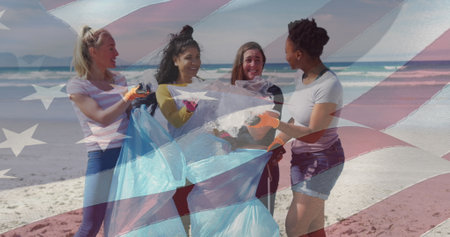 Composite image of american flag against group of diverse female volunteers cleaning the beach. environmental protection conceptの写真素材