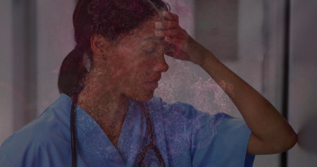 Digital waves against stressed female health worker sitting in the corridor at hospital. medical...