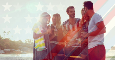 Image of flag of usa over diverse group of friends drinking beer outdoors. happiness, freedom, spending time with friends concept digitally generated image.の写真素材