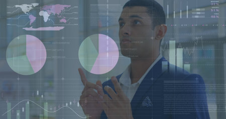 Image of statistics and financial data processing over biracial businessman. global data processing, business, finance and economy concept digitally generated image.の写真素材