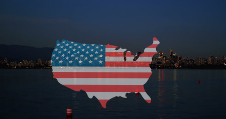 Image of map of usa with usa flag appearing over night cityscape. city life and american patriotism concept digitally generated image.の写真素材