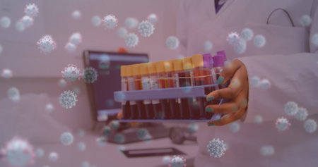 Image of virus cells over biracial female scientist with test tubes. Global science and digital interface concept digitally generated image.の写真素材