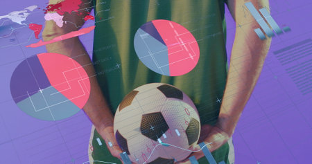 Image of charts and data on interface over caucasian male football player holding ball. Digital interface, data, communication, competition and sport digitally generated image.の写真素材