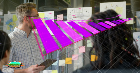Image of graphs over diverse businessman with tablet explaining project ideas to coworkers. Digital...