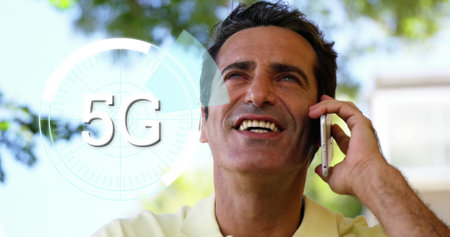 Image of 5g text over round scanner against caucasian man talking on smartphone at a park. Global networking and business technology conceptの写真素材