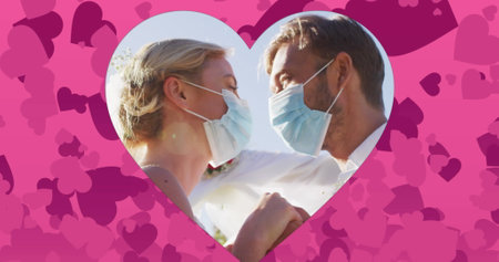 Image of hearts over married caucasian couple with face masks. social media and communication interface concept digitally generated image.の写真素材