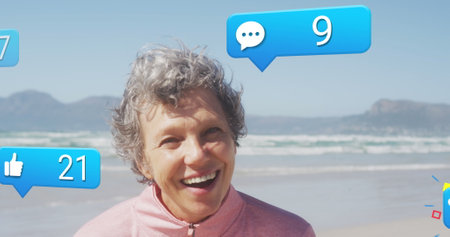 Image of social media data processing over caucasian woman smiling on beach. Global fitness,...