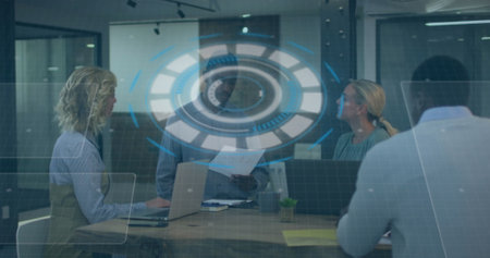 Image of interface with data processing over diverse colleagues discussing together at office. Computer interface and business technology conceptの写真素材