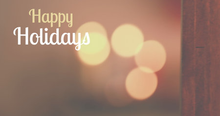 Warm lights glowing softly in background, Happy Holidays text shining. A festive mood fills the air with holiday cheer and bright colorsの写真素材