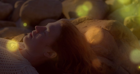 Image of stars over caucasian woman at beach. Free time and holidays concept digitally generated...