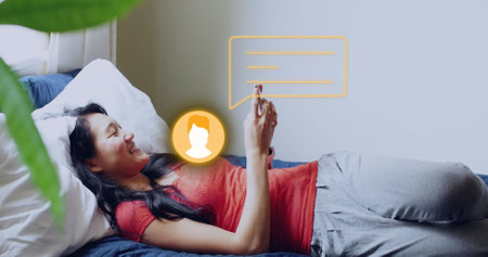 Image of social media icons and data processing over biracial woman using smartphone. Global social media, business, finance, computing and data processing concept digitally generated image.の写真素材