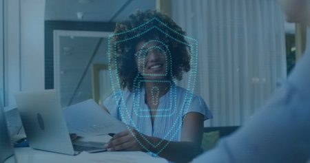 Image of online security padlock, lights over biracial businesswoman in office. Global data processing, computing and business concept digitally generated image.の写真素材