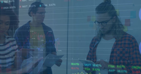 Image of stock market data processing and diverse colleagues with documents discussing at office. Global economy and business technology conceptの写真素材