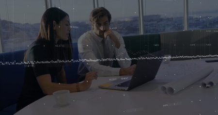 The executives are discussing and planning 4k. they are looking at a laptop on a table in an office....