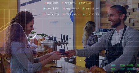 Image of trading board and graphs over caucasian male barista giving coffee to woman at counter. Digital composite, multiple exposure, stock market, cafes, finance, drink and investment concept.の写真素材