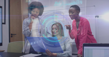 Image of round scanner and data processing over three diverse women discussing at office. Computer interface and business data technology conceptの写真素材